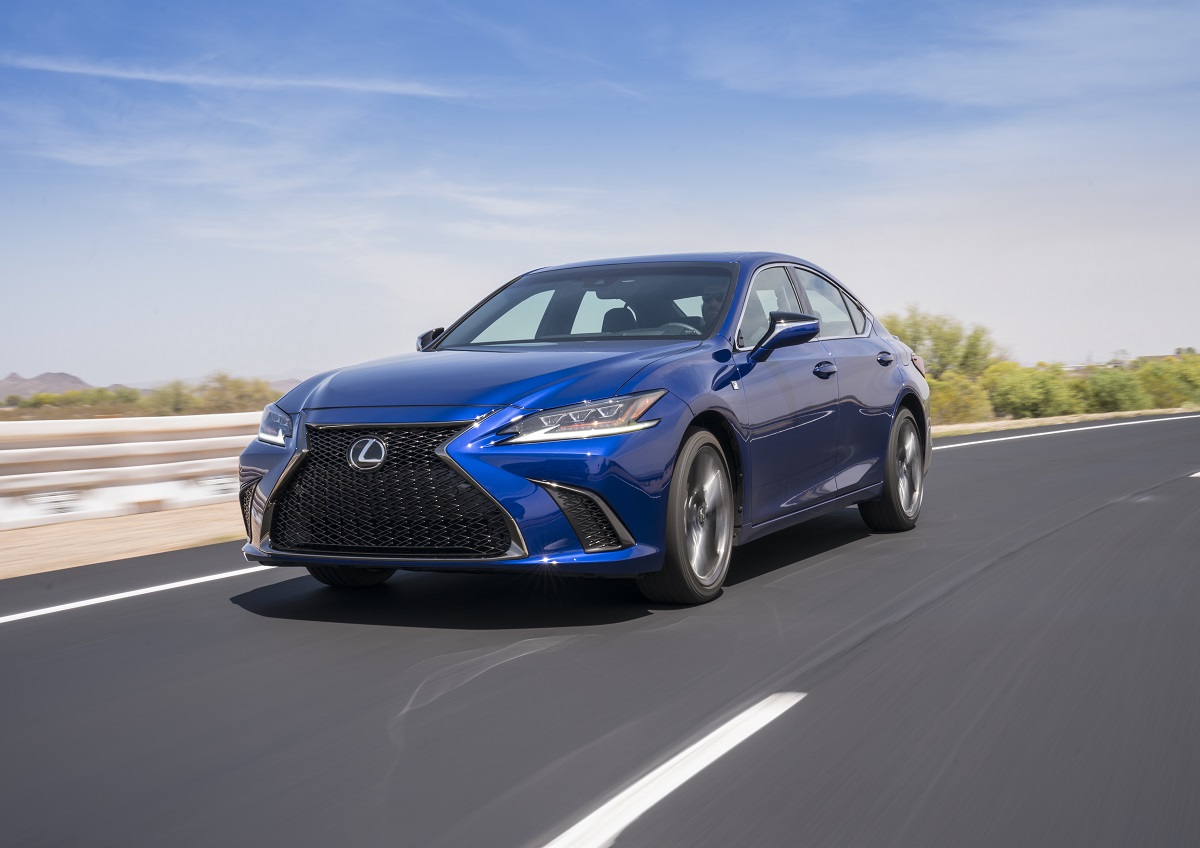 A blue Lexus ES shows off its luxury car styling on a desert road.