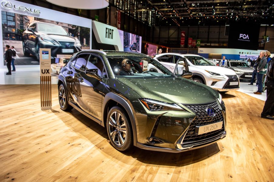 A green Lexus UX on display at an auto show