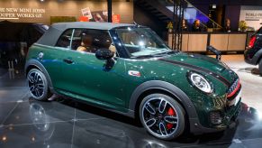 A Mini Cooper convertible on display at an auto show