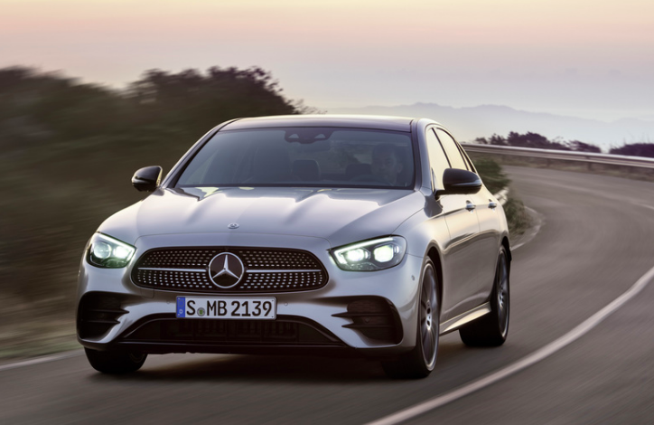 a new E-class sedan driving on the road