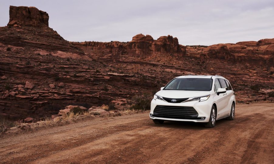 white 2021 Sienna minivan diving on a dirt road