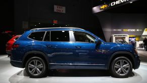 A blue Volkswagen Atlas on display at an auto show