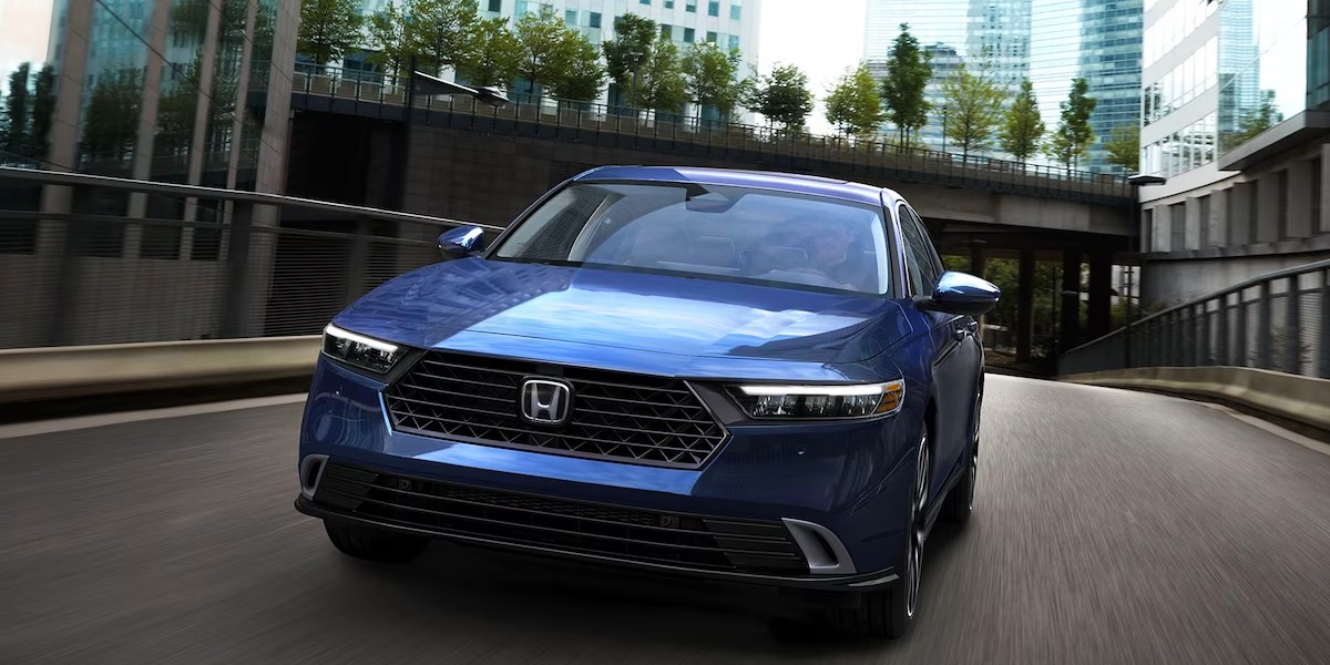 Accord sales: A blue Honda Accord midsize sedan drives on the road. It just outsold the Toyota Camry in August 2023.