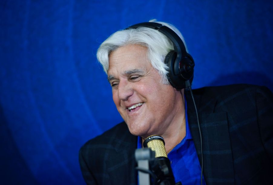 Jay Leno doing a radio interview and smiling