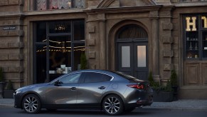 a gray Mazda 3 parked in the city