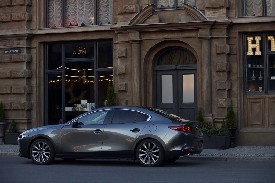 a gray Mazda 3 parked in the city