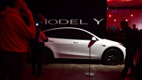 People view a model of the new Tesla Model Y unveiled earlier in Hawthorne, California