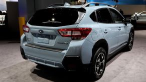 A Subaru Crosstrek seen from the back at an auto show