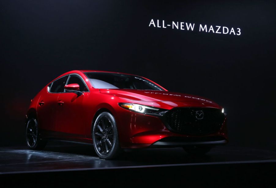 A Mazda3 being debuted at an auto show