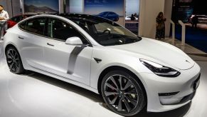 Tesla Model 3 compact sedan car in white on display at Brussels Expo