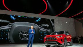 Toyota Motor North America Vice President and General Manager shows the Toyota RAV4 Hybrid at AutoMobility LA