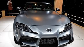 A titanium colored Supra sits on display at a car show