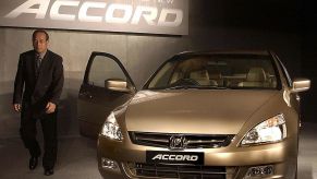 President and Chief Executive Officer (CEO) of Honda Siel Cars India Ltd. H Yamada walk pass the all new Honda Accord car during its launch in New Delhi, 10 June 2003