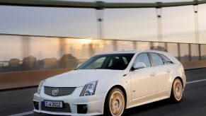 White 2011 Cadillac CTS-V Wagon driving on a city bridge