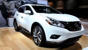 People discuss a Nissan 2015 Murano on display at the LA Auto Show's press and trade day