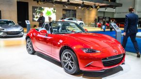 A red Mazda MX-5 Miata on display at an auto show