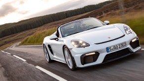 White 2020 Porsche 718 Spyder being driven down a curvy road