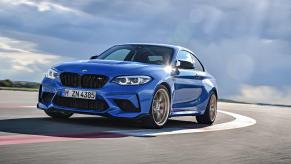 A blue 2021 BMW M2 CS taking a tight track corner