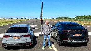 Gray Audi RS6 Avant vs black Lamborghini Urus in a drag race on an airfield