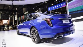 A blue Cadillac CT5 on display at an auto show