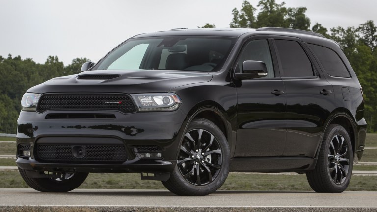 a black on black Dodge Durango parked on pavement