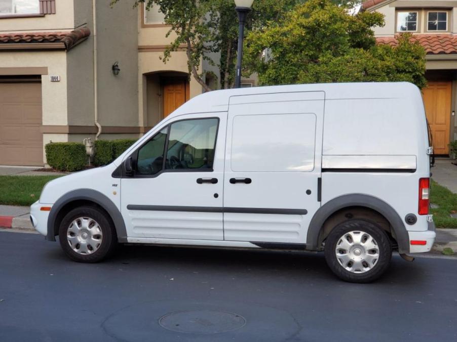 A Ford Transit work van parked outside a house.