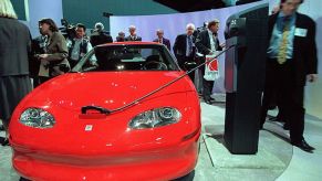 a red electric vehicle at a car show