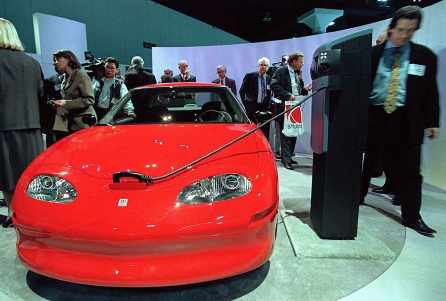 a red electric vehicle at a car show