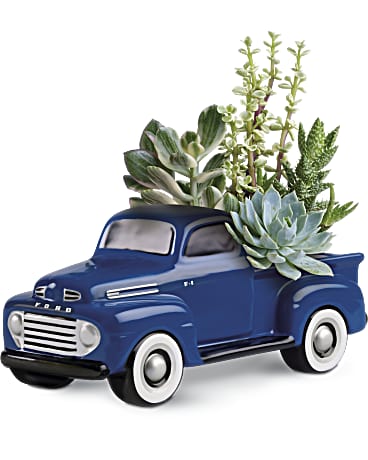 a pickup truck pot full of succulents