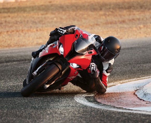 a red BMW leaning deep into a chicane