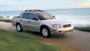 a Subaru Baja utility truck driving along the coast