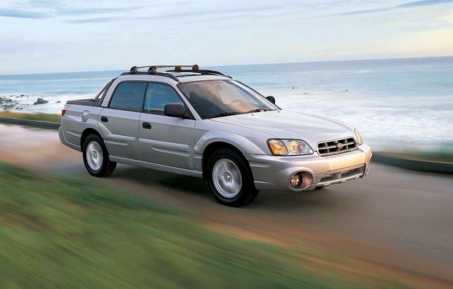 a Subaru Baja utility truck driving along the coast