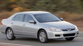 a silver seventh gen Honda Accord driving on a scenic road