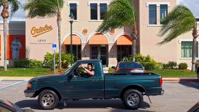 A person driving a Mazda B-Series truck