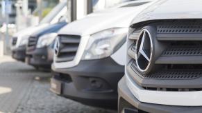 Mercedes-Benz Sprinter vans parked in a dealership parking lot.