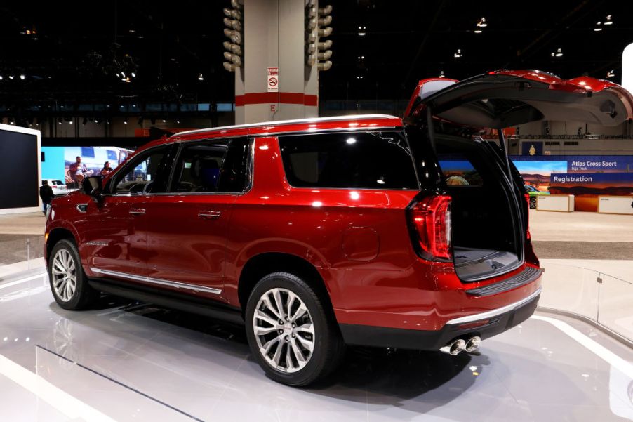 A red GMC Yukon on display at an auto show