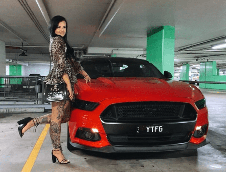 Supercar driver Renee Gracie poses with red Mustang