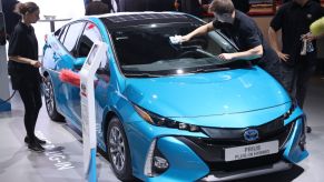 Workers prepare a Toyota Prius plug-in hybrid at the 2017 Frankfurt Auto Show on September 12, 2017