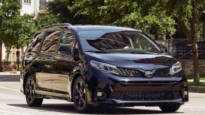 black on black Toyota Sienna driving in a neighborhood