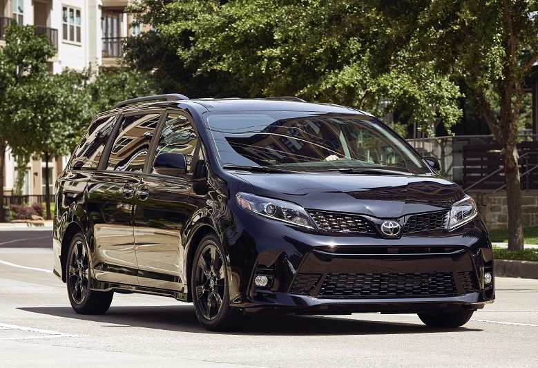 black on black Toyota Sienna driving in a neighborhood