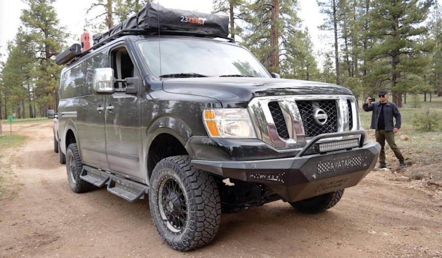 A pic of the front passenger side of a black van that received anoverlanding conversion