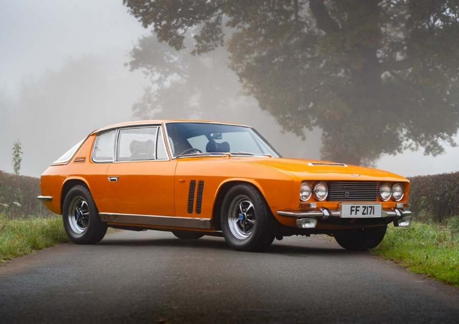 An orange 1969 Jensen Interceptor FF Mk I on a foggy countryside road