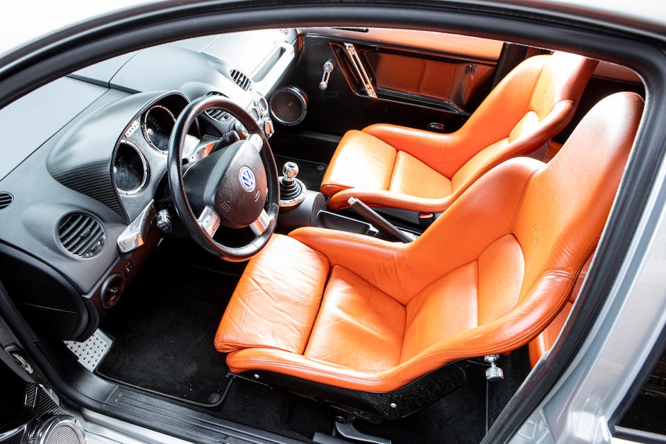 An interior shot of the 2001 Volkswagen Beetle RSI, showing the tan leather seats and carbon-fiber trim