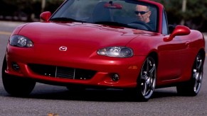 A red 2004 Mazdaspeed MX-5 Miata going around a corner