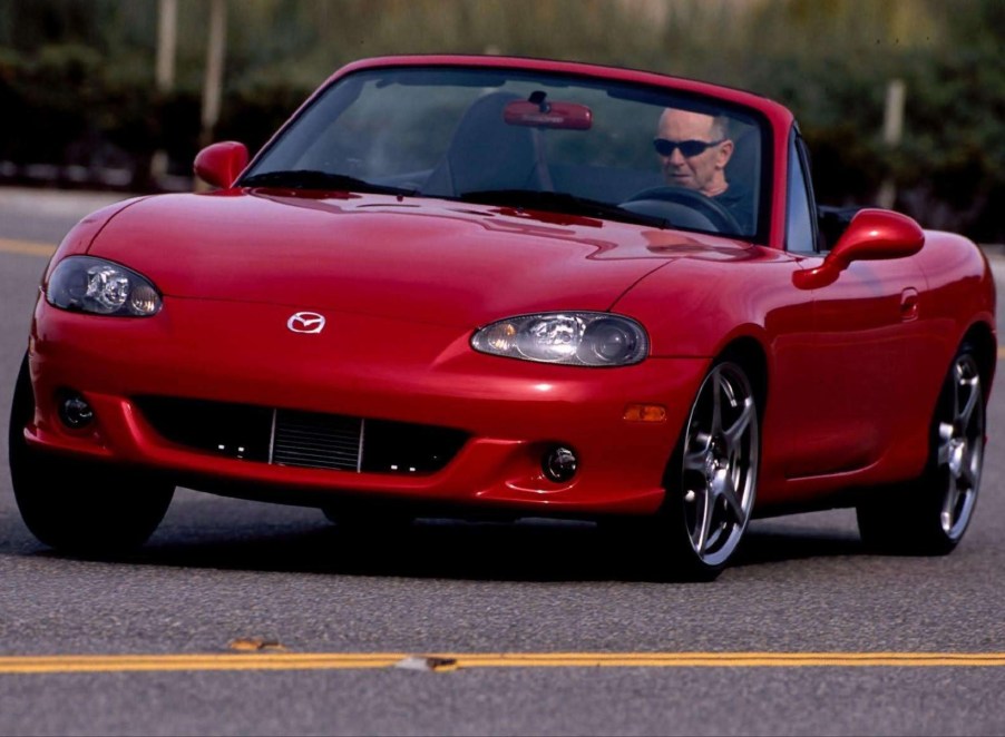 A red 2004 Mazdaspeed MX-5 Miata going around a corner