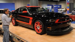 A man looks at the new black 2010 Mustang on display at the Orange County Auto Show