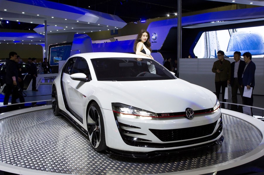 Models pose next to a 2015 Volkswagen GTI at the Seoul Motor Show