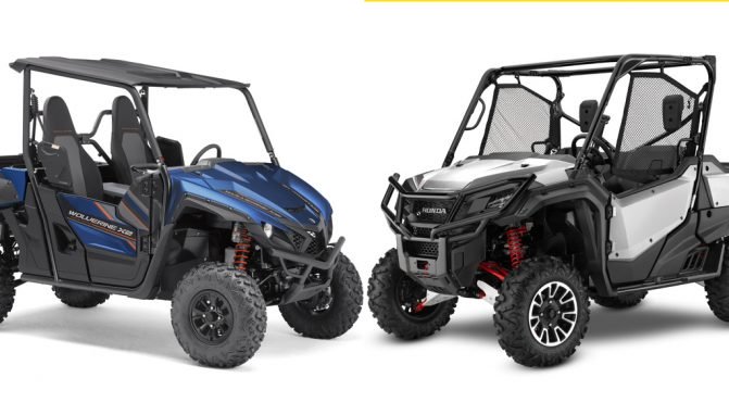 A honda and Yamaha utv poised head to head against a white backdrop