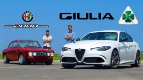 A white 2020 Alfa Romeo Giulia Quadrifoglio in front of a red 1973 Alfa Romeo 2000 GTV