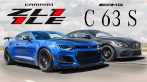 A blue 2020 Chevrolet Camaro ZL1 1LE drives next to a matte gray 2020 Mercedes-AMG C63S coupe